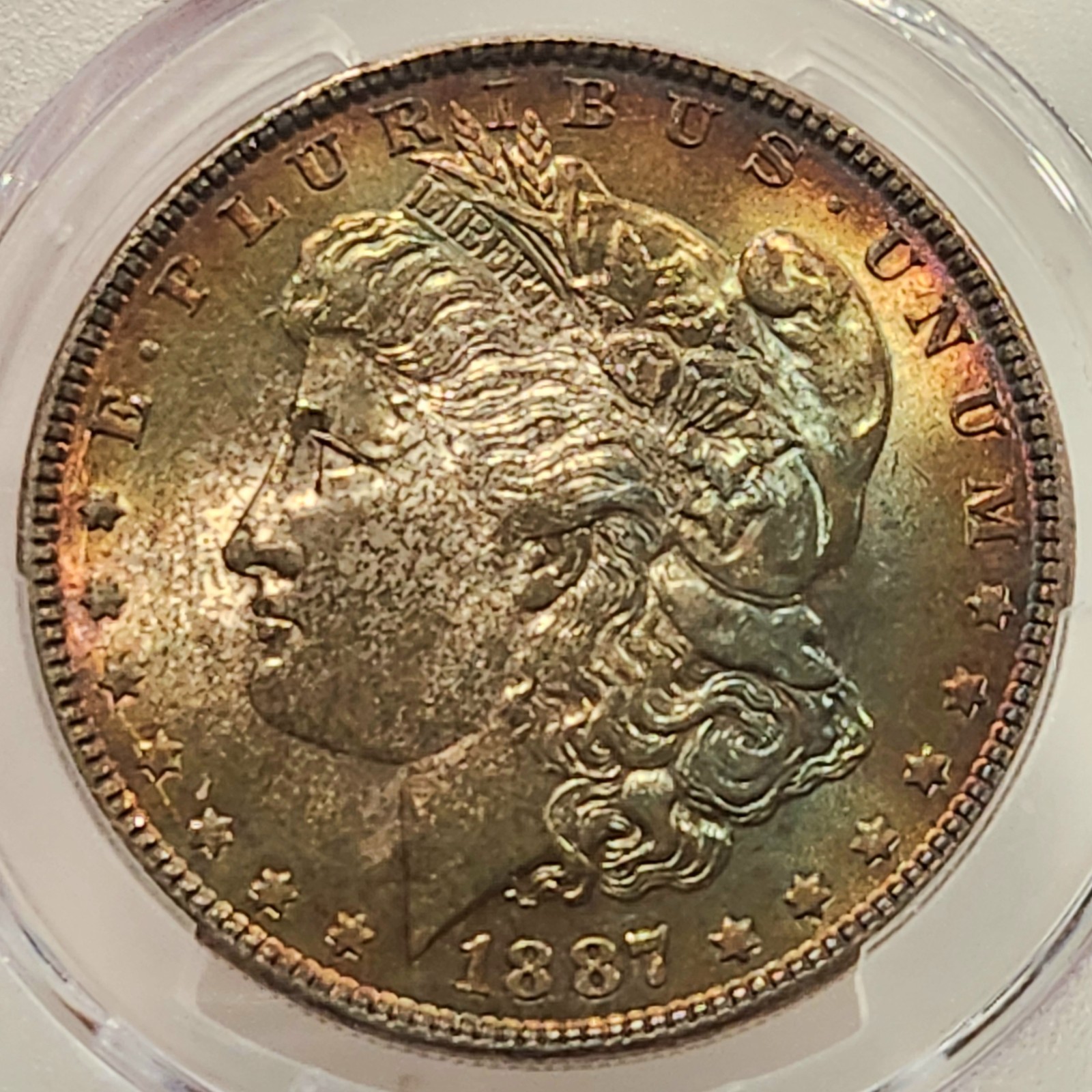 1887 Morgan Silver Dollar PCGS MS65 – Gorgeous Gold & Emerald Toning – Gem BU $1