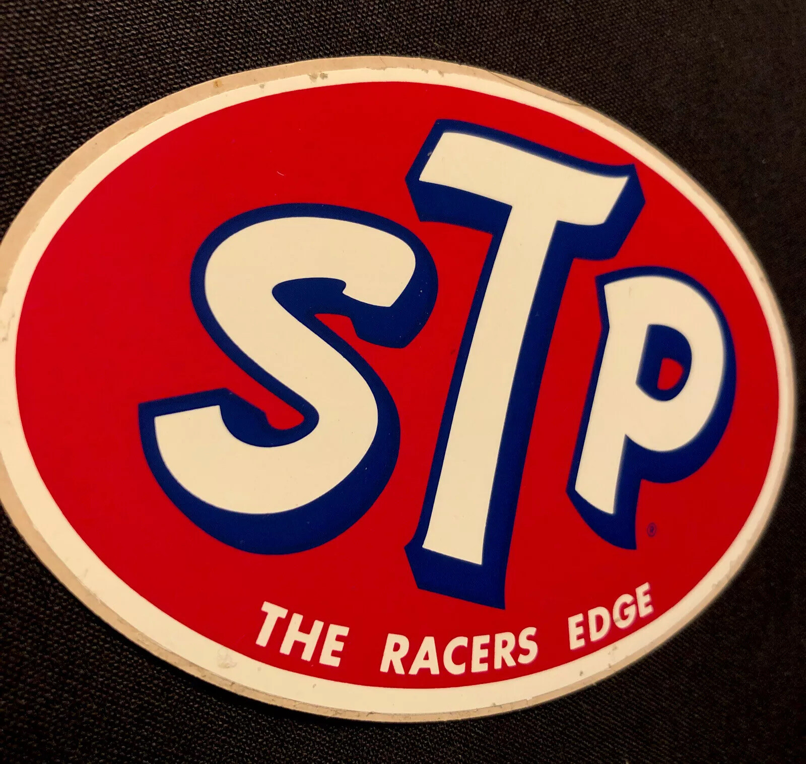 STP STICKER “THE RACERS EDGE” 4 3/4 X 3 1/4“ VINTAGE GOOD/ MODERATE CONDITION!