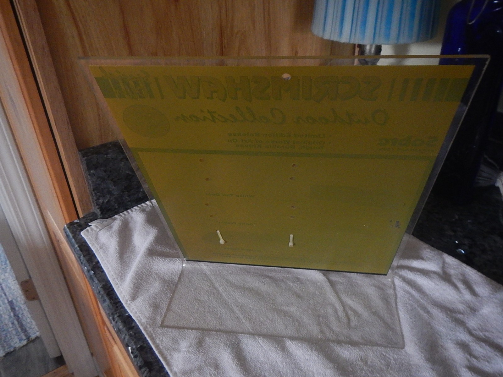 Vintage Sabre scrimshaw knife counter top store display with one NOS knife