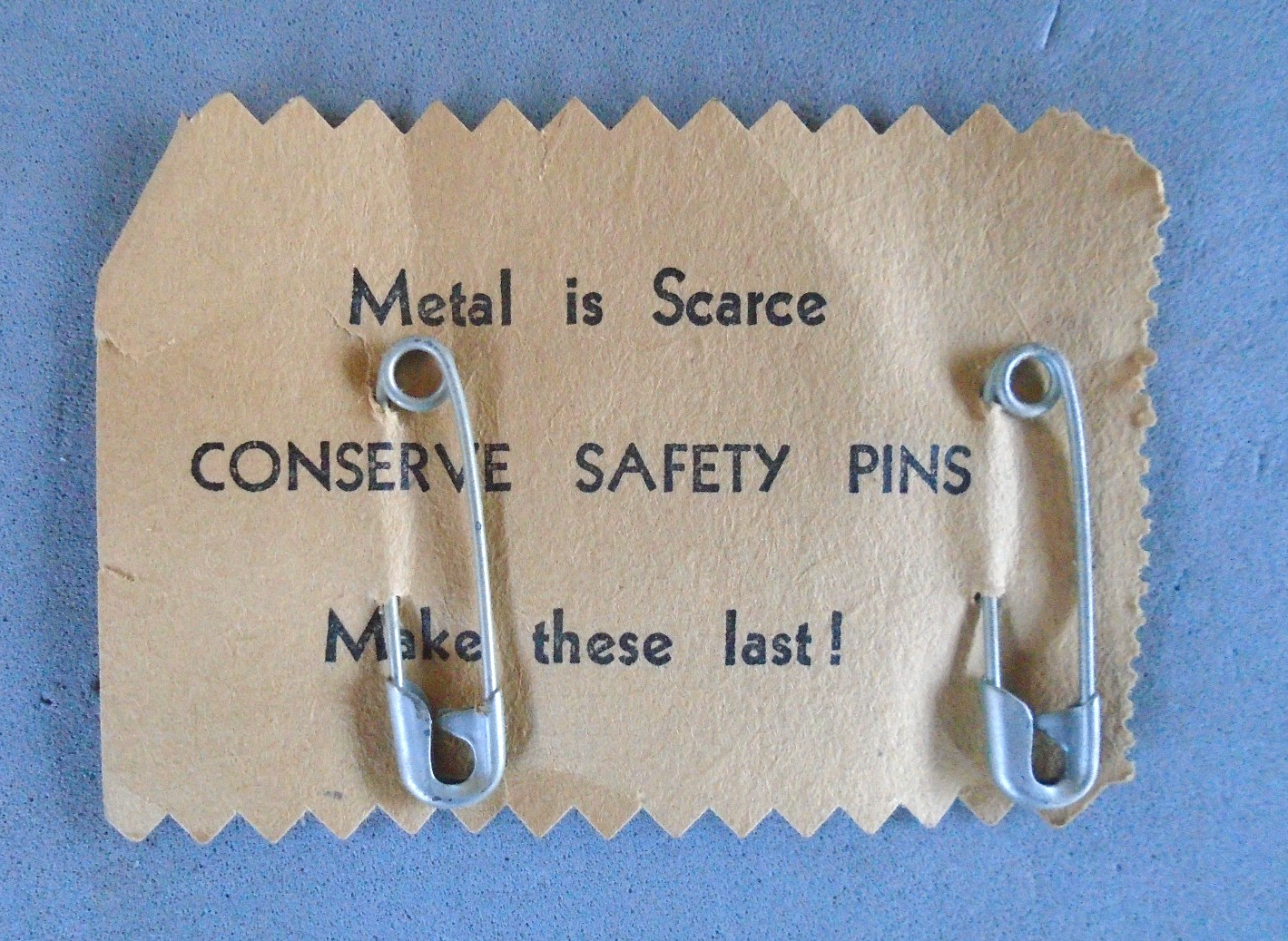 WWII metal is scarce, conserve safety pins cardboard with pins