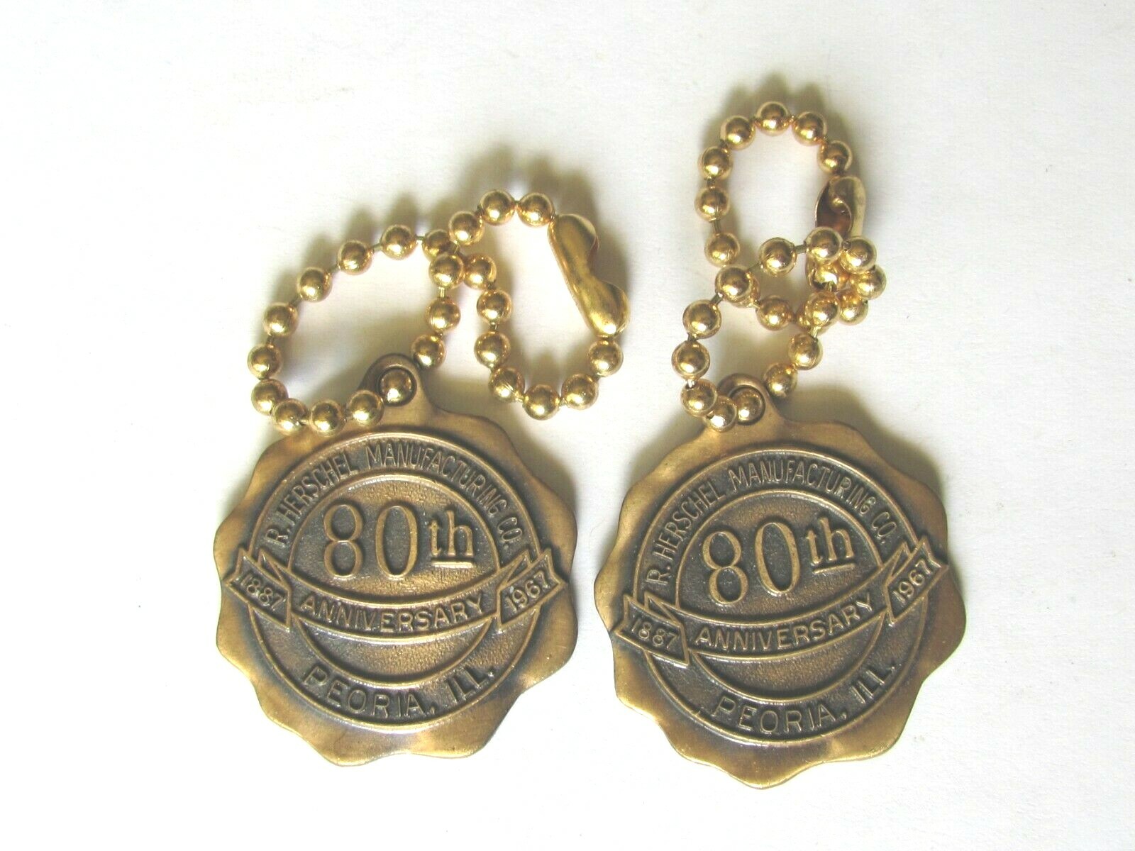 2 HERSCHEL MFG CO PEORIA IL 1967 80th ANNIVERSARY KEY CHAIN FOB FARM MOWER
