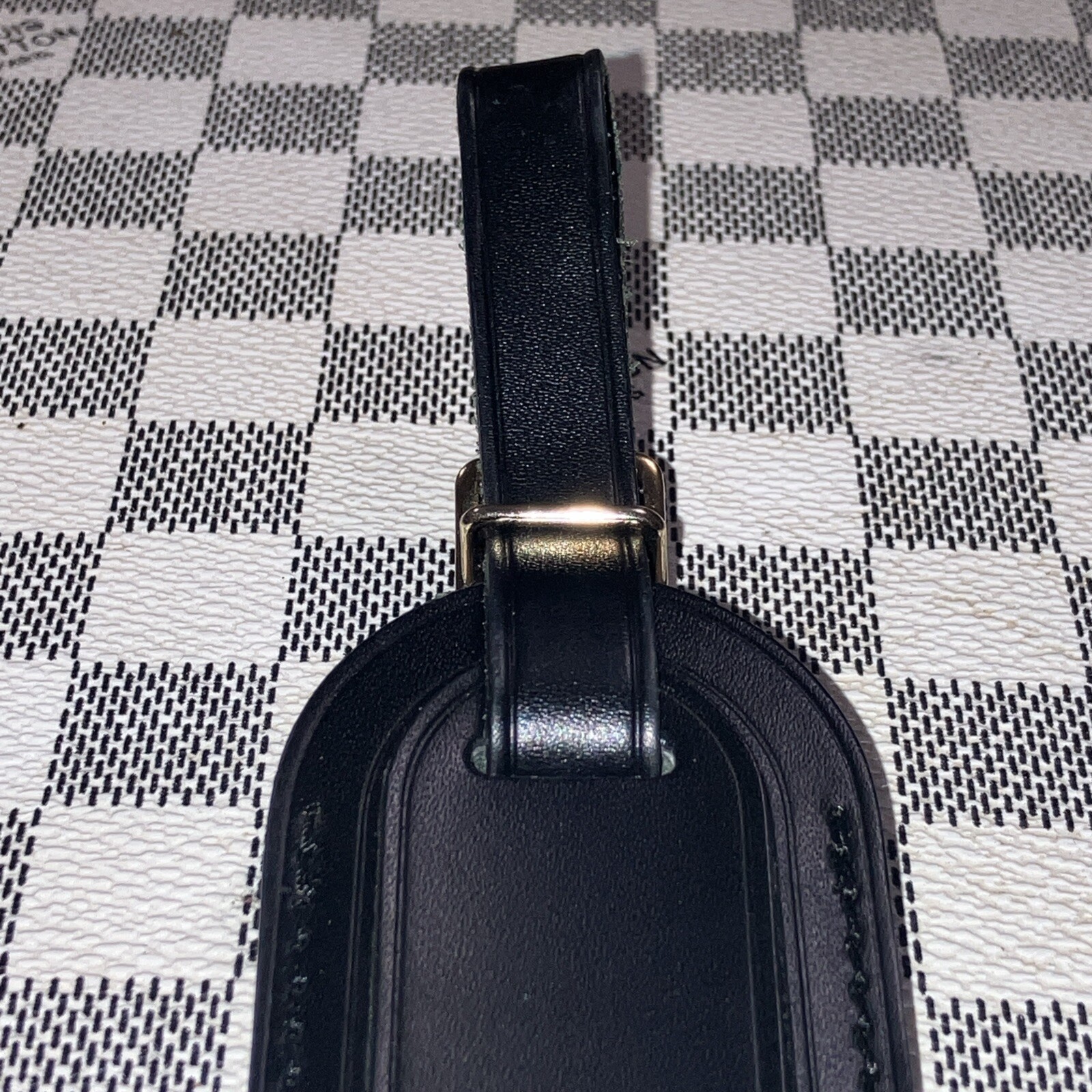 Authentic Louis Vuitton small Black W/ Gold Hardware name tag.