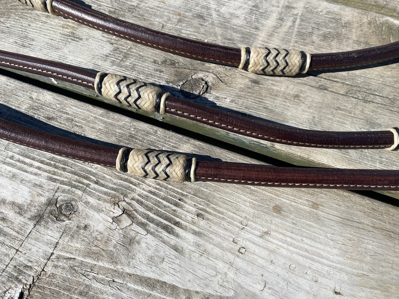 Rolled Argentine leather quick change Romel reins w/braided rawhide accents