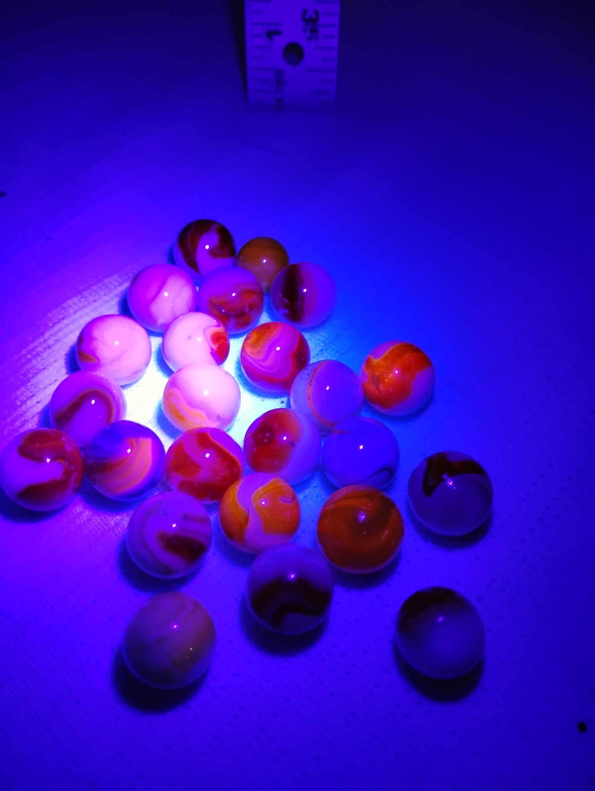 Lot of 24 Cadium filled Glass marbles. Glows red under blacklight