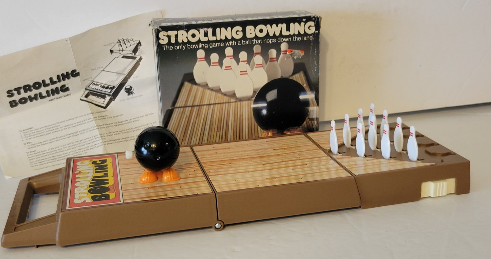 VINTAGE 1980s TOMY WIND UP STROLLING BOWLING GAME WITH BOX WORKING