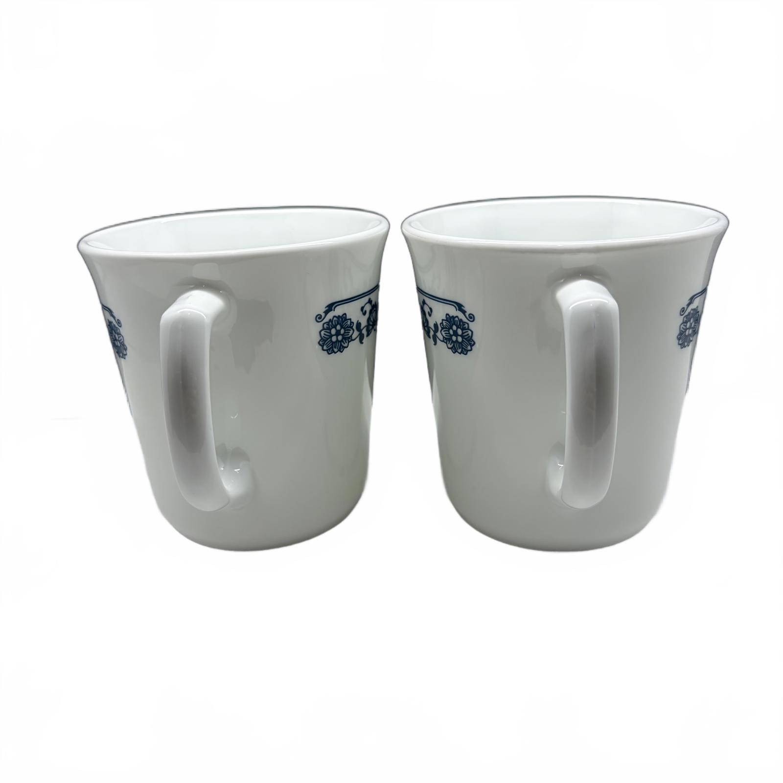 Two white Corning Ware Old Town Blue ceramic mugs with blue floral border.