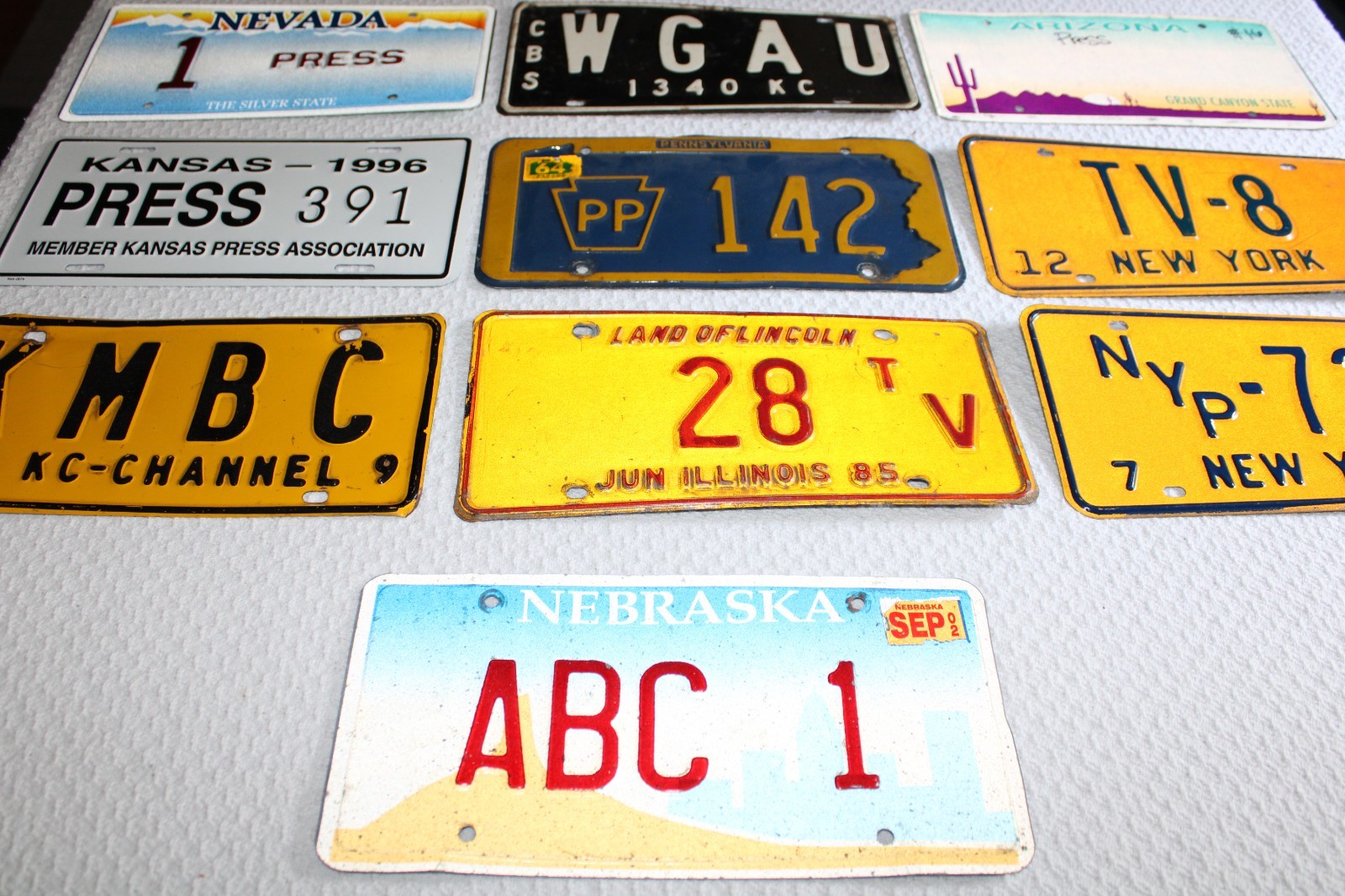 COLLECTION OF (9) NEWS/MEDIA/TV/RADIO PRESS LICENSE PLATES FROM VARIOUS STATES