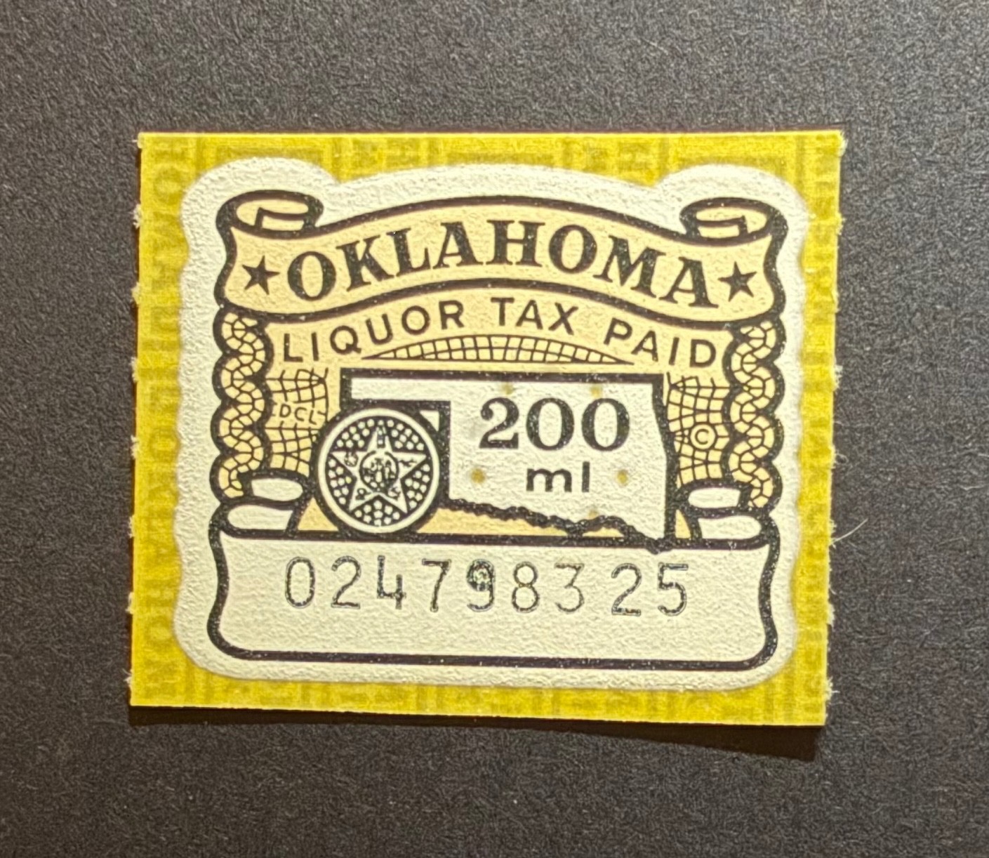 Oklahoma State Revenue - 200 ml yellow-brown, black & white Liquor Tax #L10 M-LH