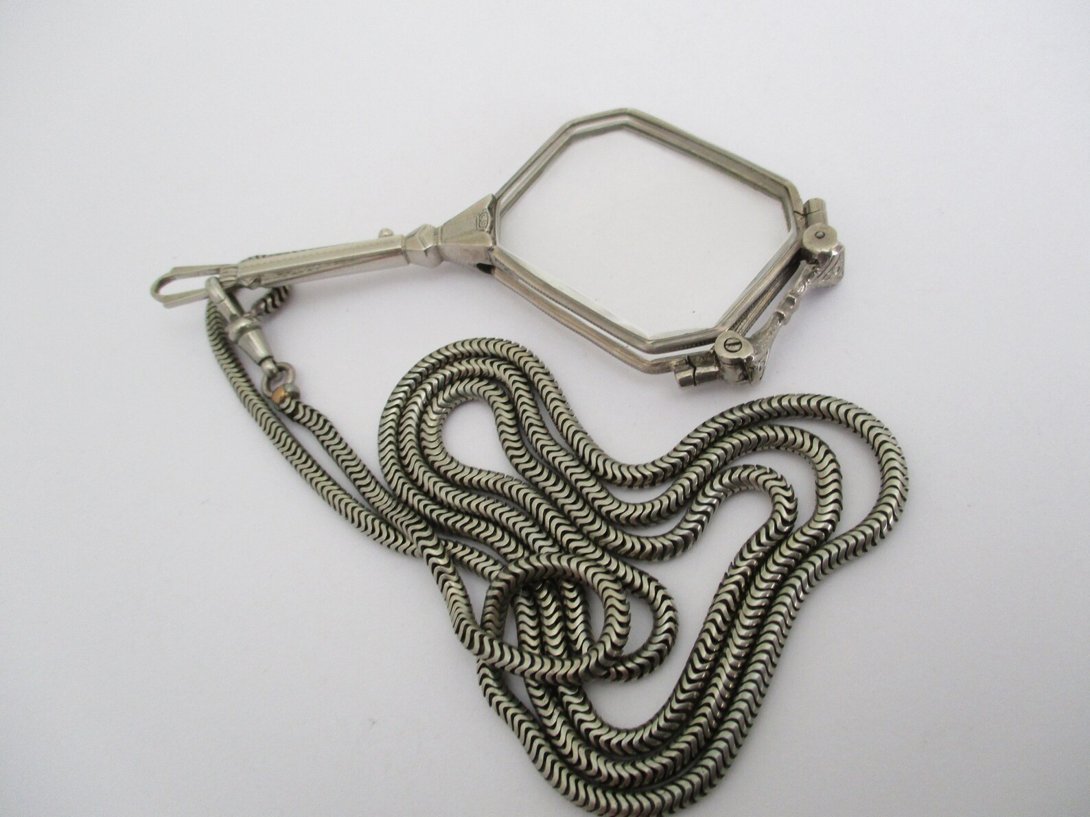 A Deco style lorgnette with guard chain