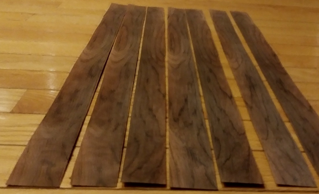 7 pieces of rosewood veneer 1 1/4" to 1 1/2" x 24 1/2" each raw 1/42"