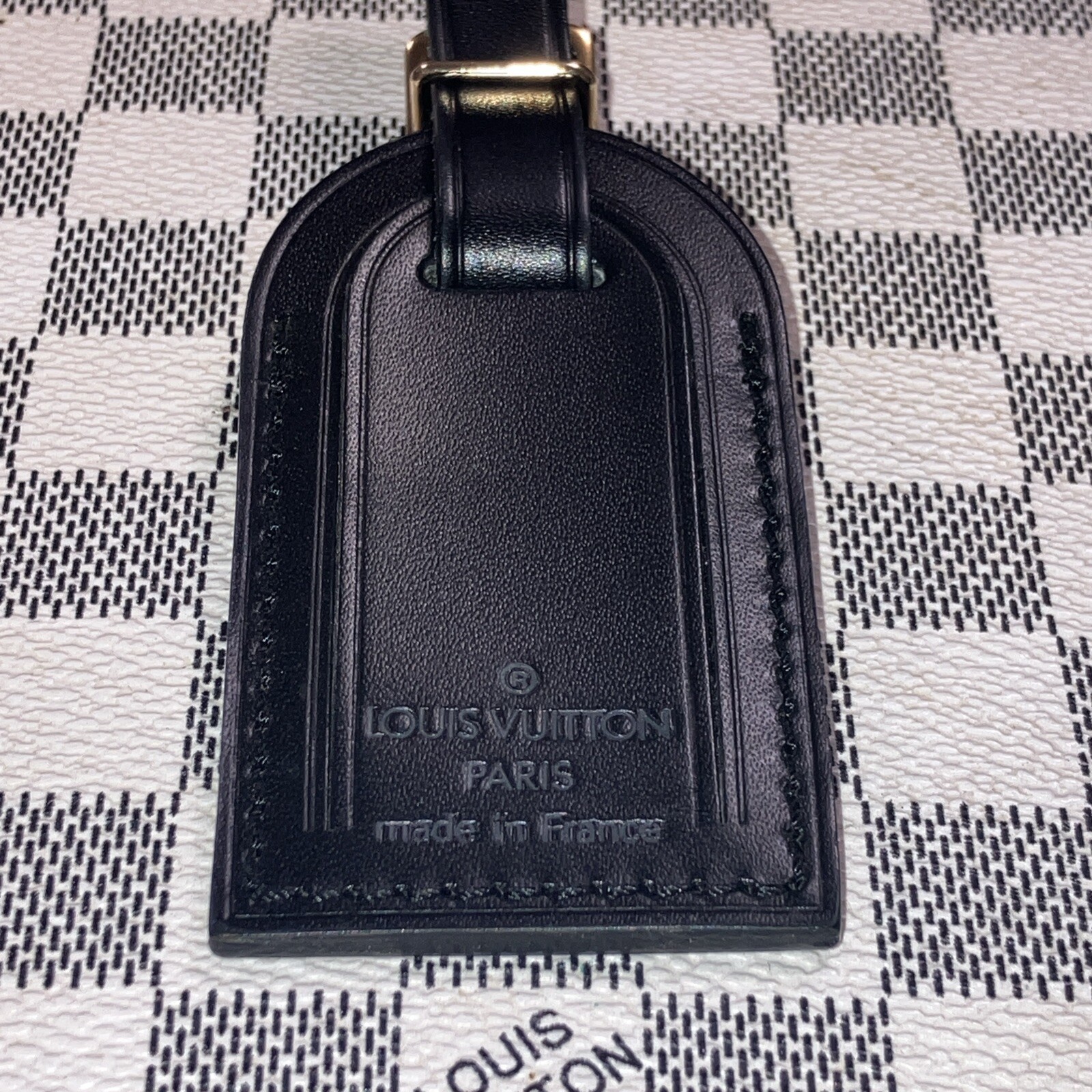 Authentic Louis Vuitton small Black W/ Gold Hardware name tag.