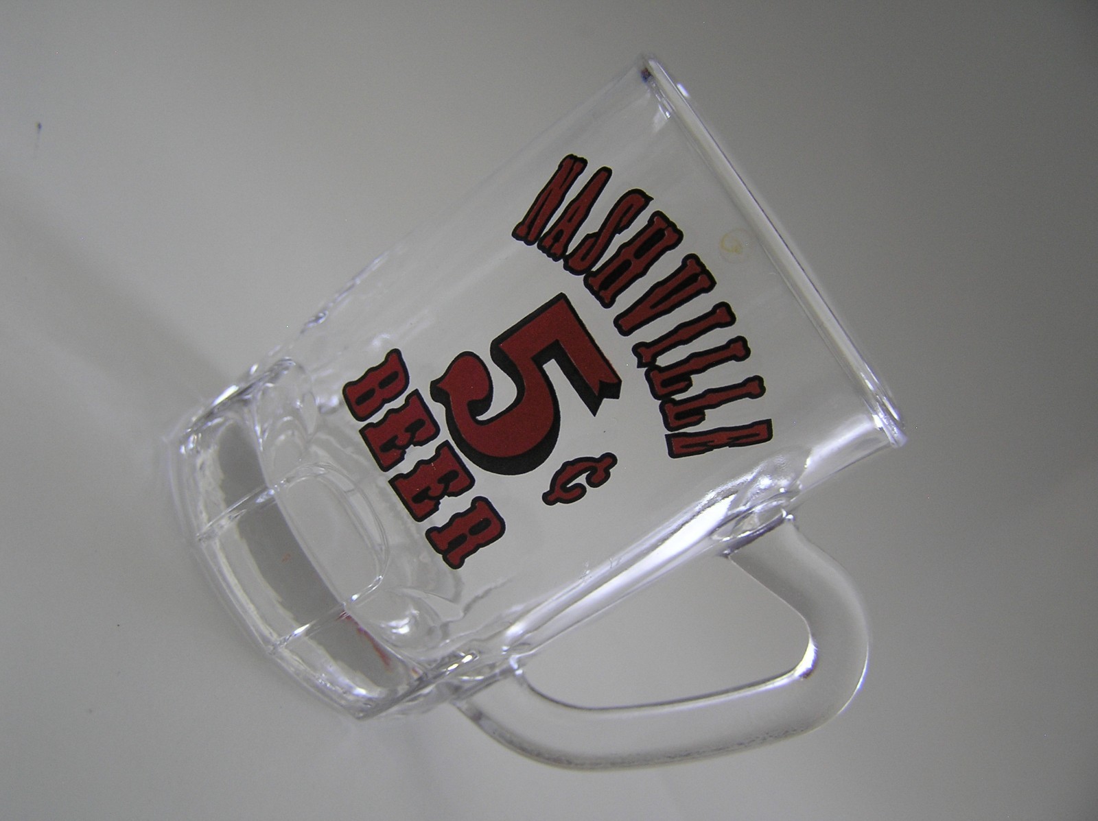 2 Souvenirs Shot Mugs: A Black Rumple Minze and A Clear Nashville 5cents Beer