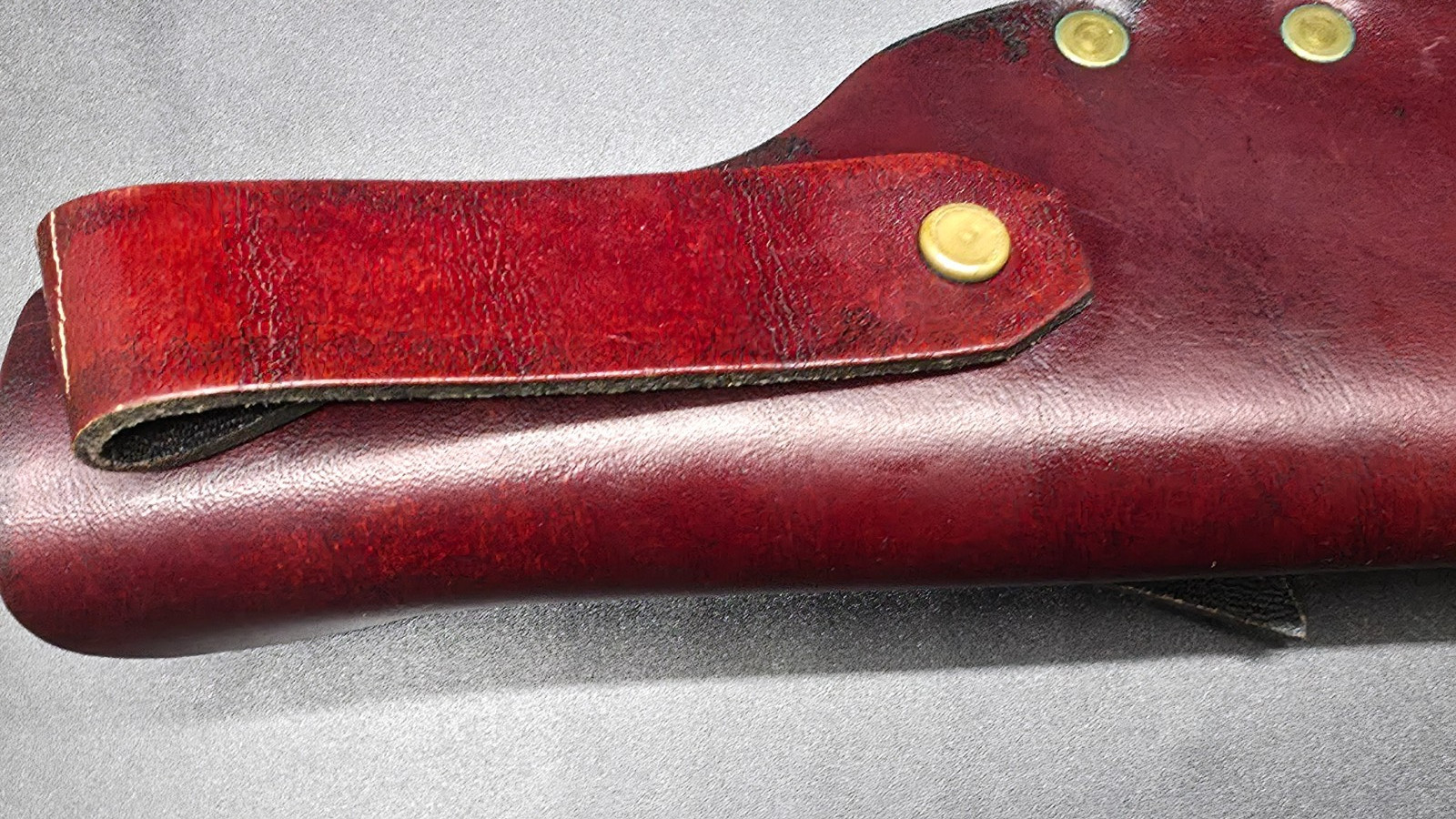 Buck Kalinga knife with black handle and brown leather sheath