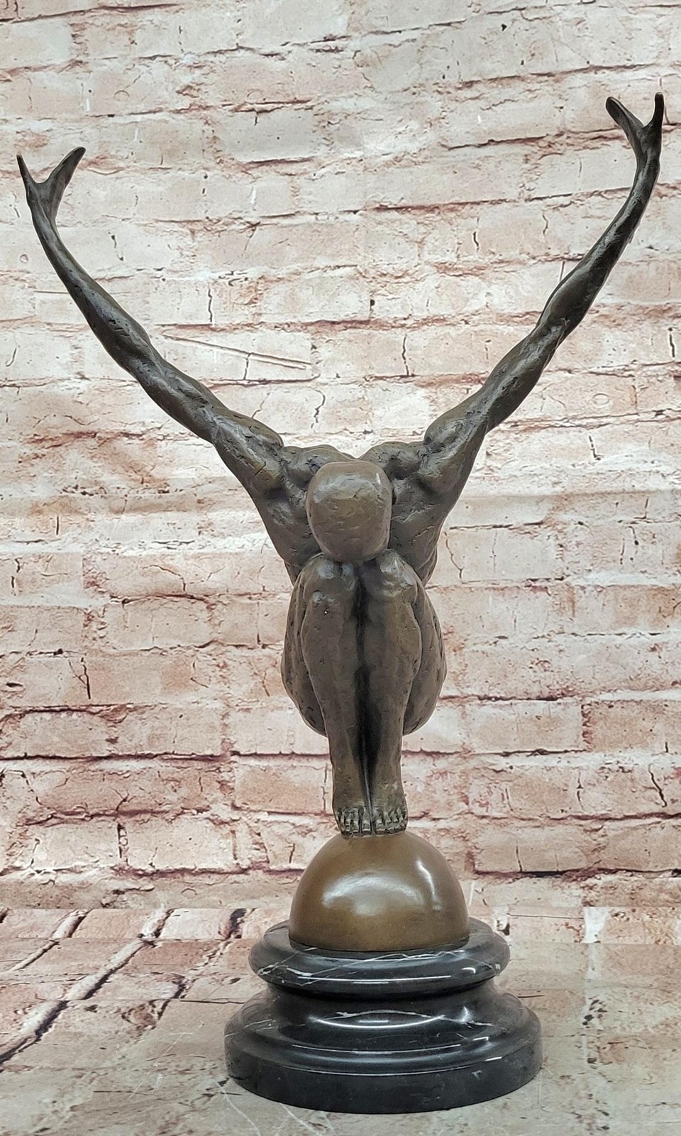 Abstract Bronze Male Figure Balancing on Sphere with Outstretched Arms Sculpture