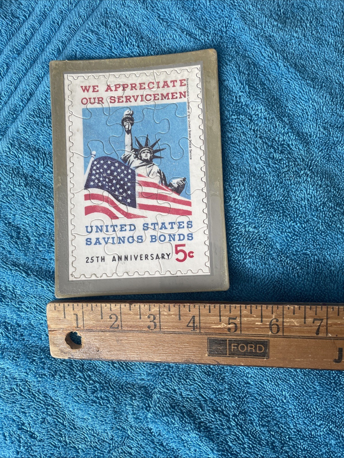 Vintage novelty puzzle resembling a US Savings Bond postage stamp.
