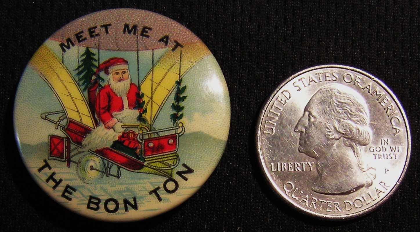 RARE ANTIQUE SANTA CLAUS "MEET ME AT THE BON TON" FLYING MACHINE AIRSHIP PIN