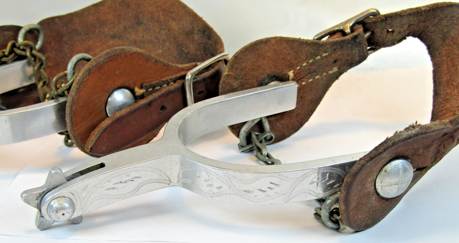 PAIR OF UNMARKED ENGRAVED ALUMINUM AIRPLANE METAL RIDING SPURS W/ STRAPS