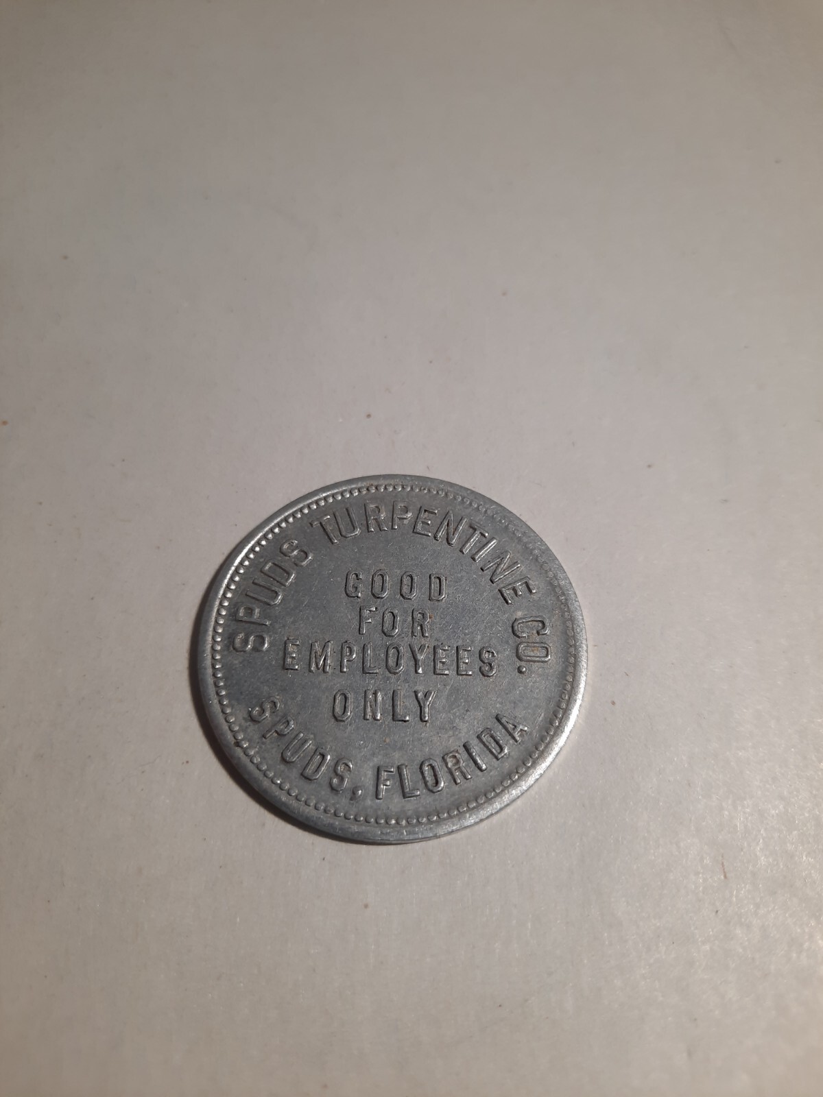 $1.00 Token: Spuds Turpentine Company, Spuds, Florida, 35mm Aluminum