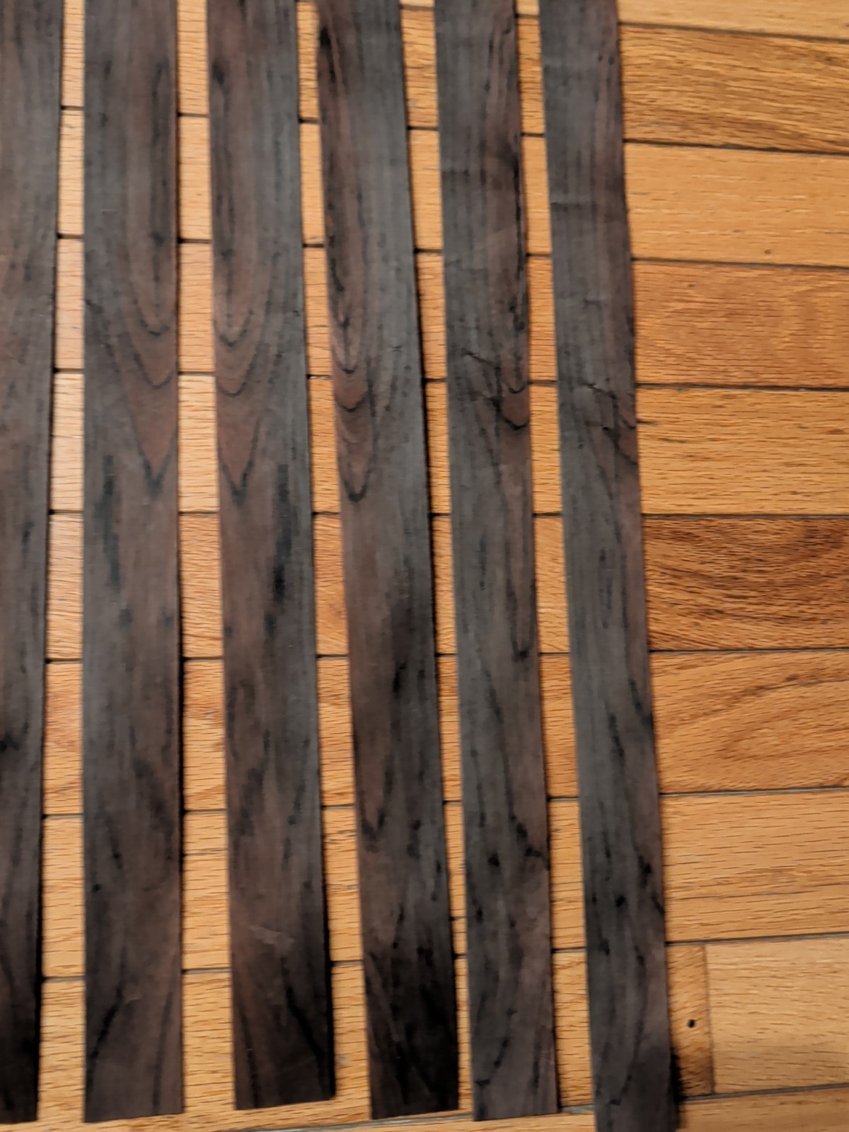 7 pieces of rosewood veneer 1 1/4" to 1 1/2" x 24 1/2" each raw 1/42"