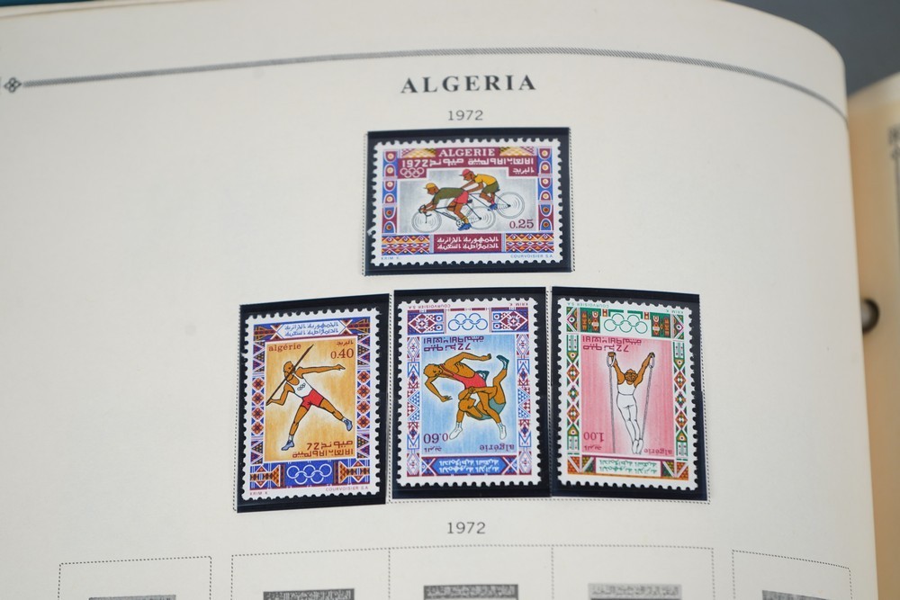WORLDWIDE A-L 1970s COLLECTION OF 875+ STAMPS MINT & USED STORED IN SCOTT ALBUM
