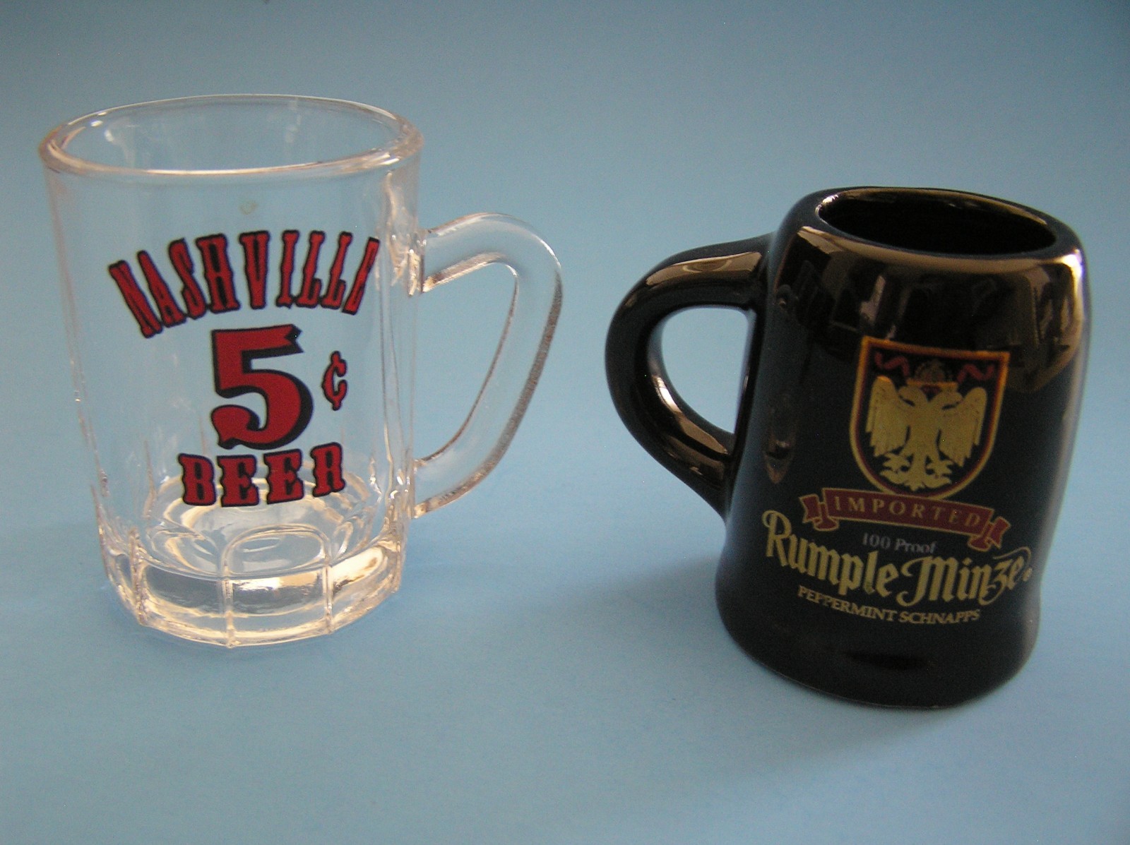 2 Souvenirs Shot Mugs: A Black Rumple Minze and A Clear Nashville 5cents Beer