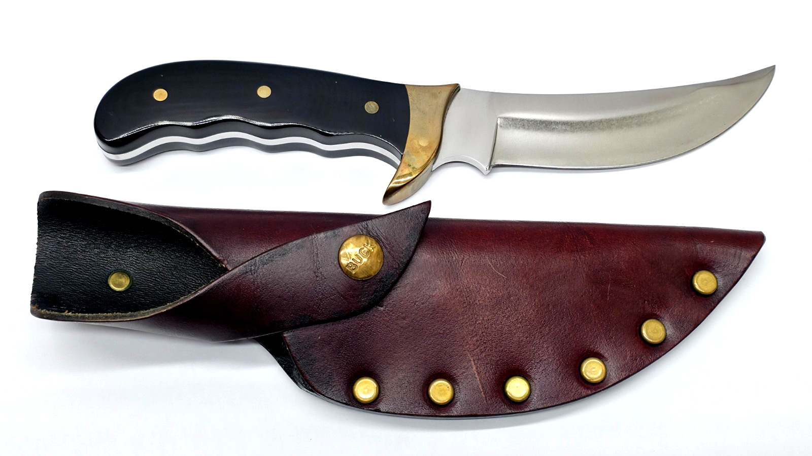 Buck Kalinga knife with black handle and brown leather sheath