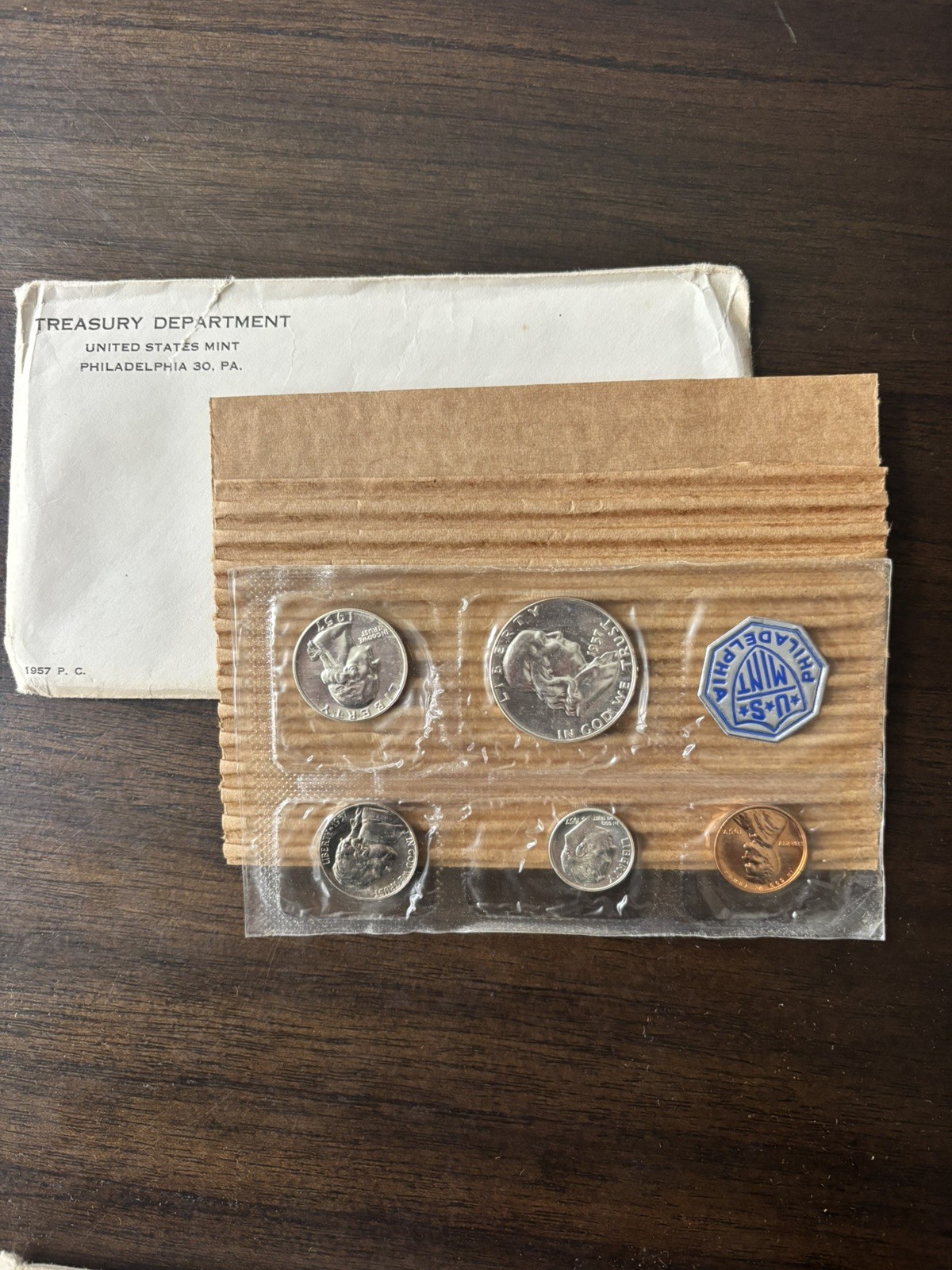 1957 U.S. PROOF SET.  Coins U.S. Mint Sealed in a flat cello. (Tear in envelope)