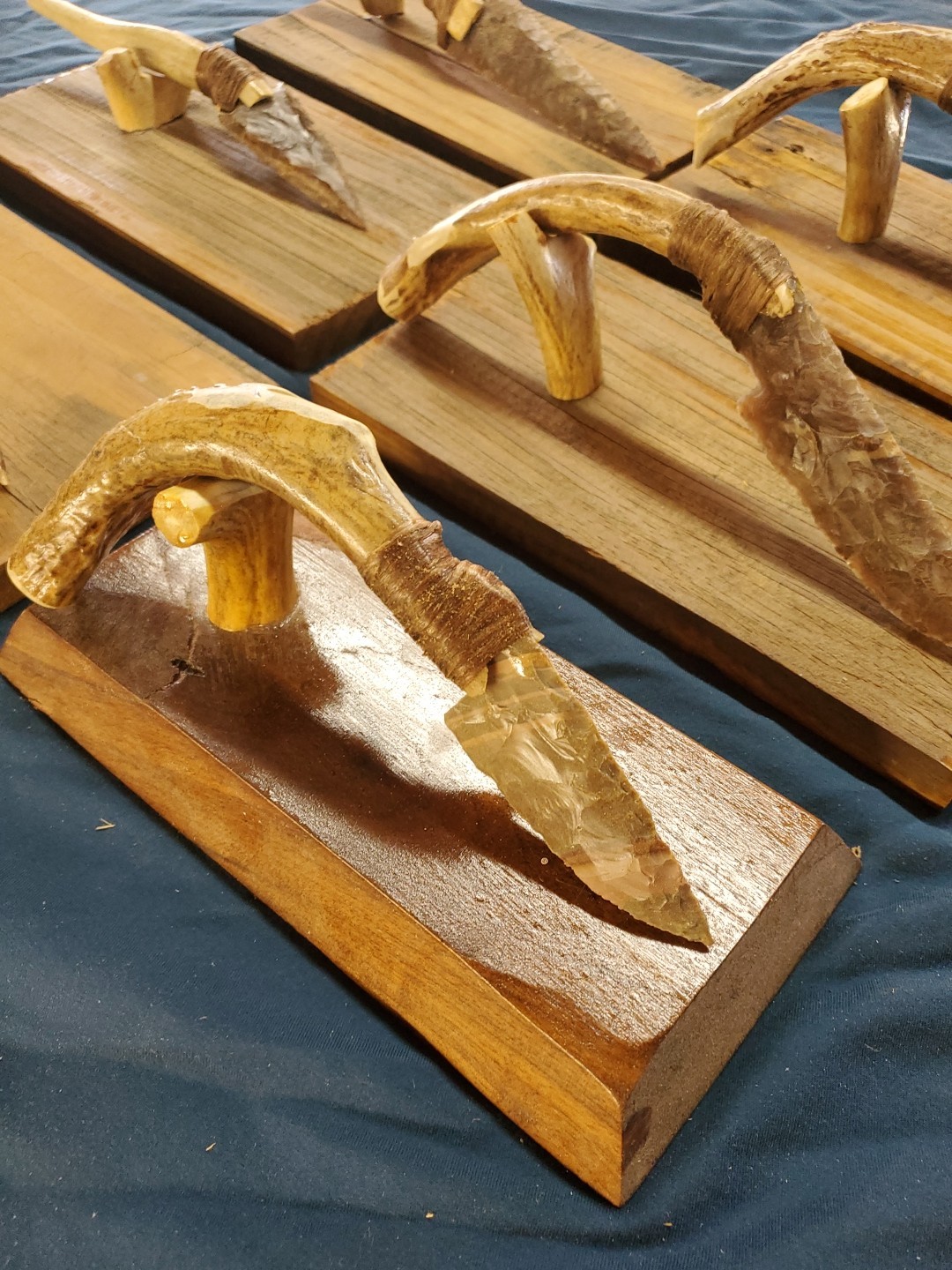 Flint Knapped Stone Arrowhead Blade Knife with Deer Antler Handle on Wood Stand