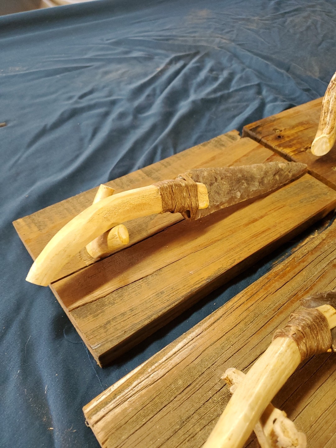 Flint Knapped Stone Arrowhead Blade Knife with Deer Antler Handle on Wood Stand