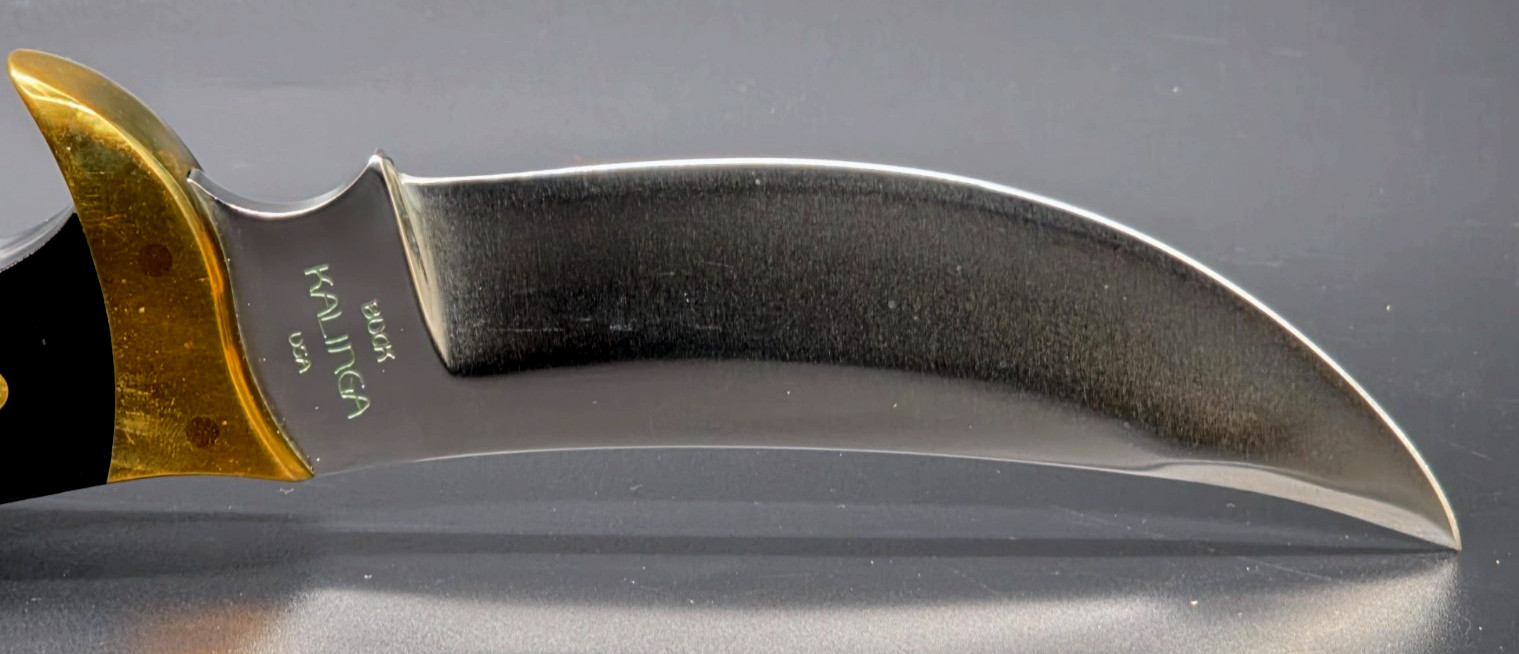 Buck Kalinga knife with black handle and brown leather sheath