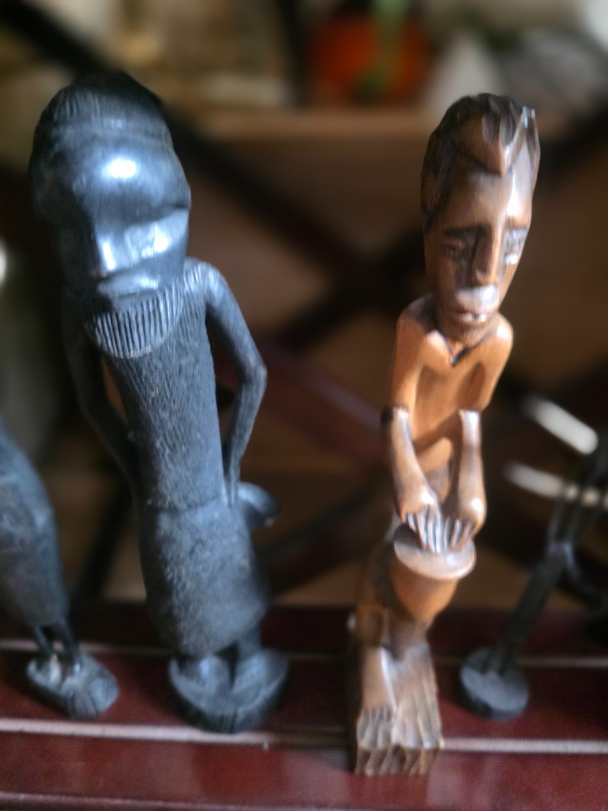 Set of carved statues from black wood, stone, bronze.