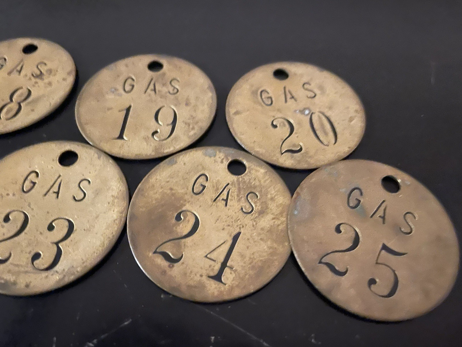 Lot of 9 vintage brass gasoline tags
