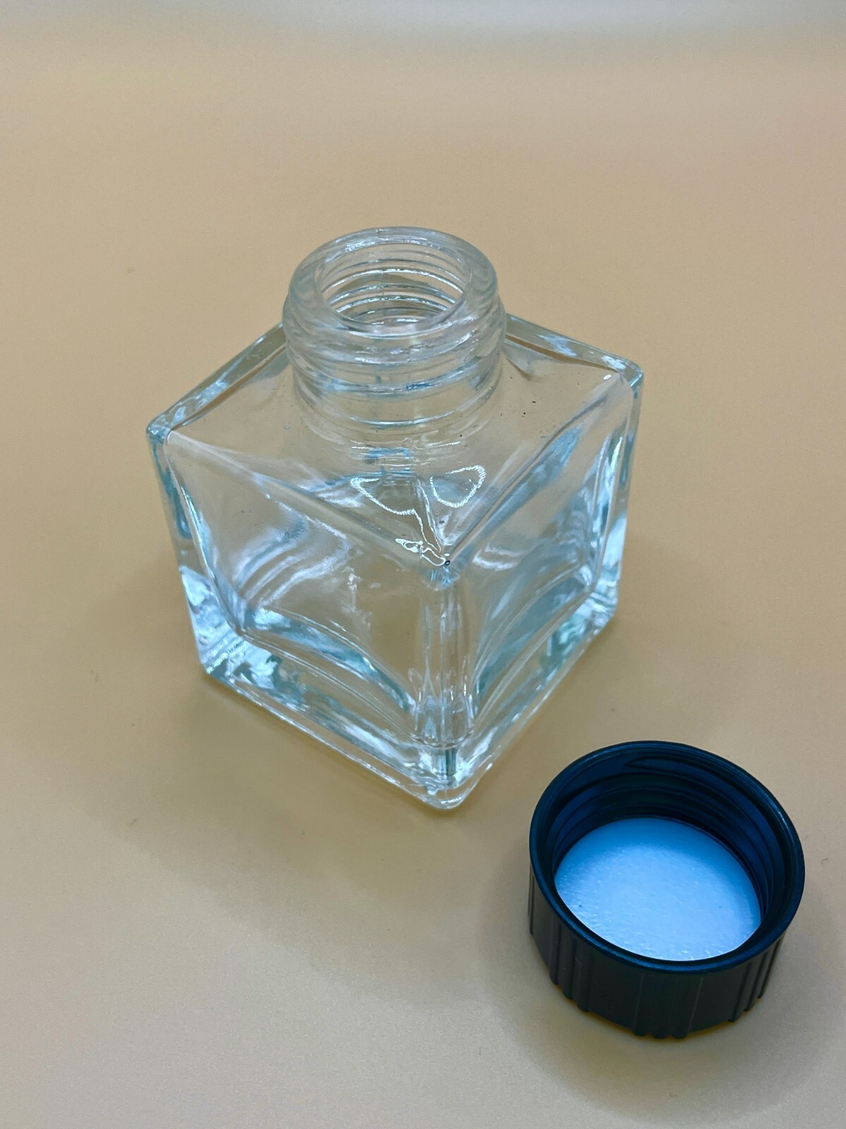 New, empty 50 ml glass square jars with lids, box of 8. Any quantity available