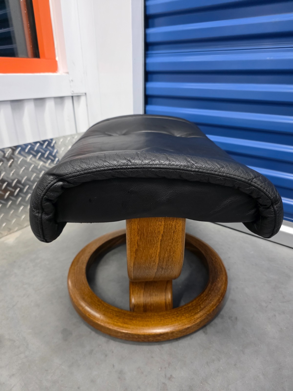 Ekornes Stressless Black Colored Leather Ottoman | Teak Stained Wood Base