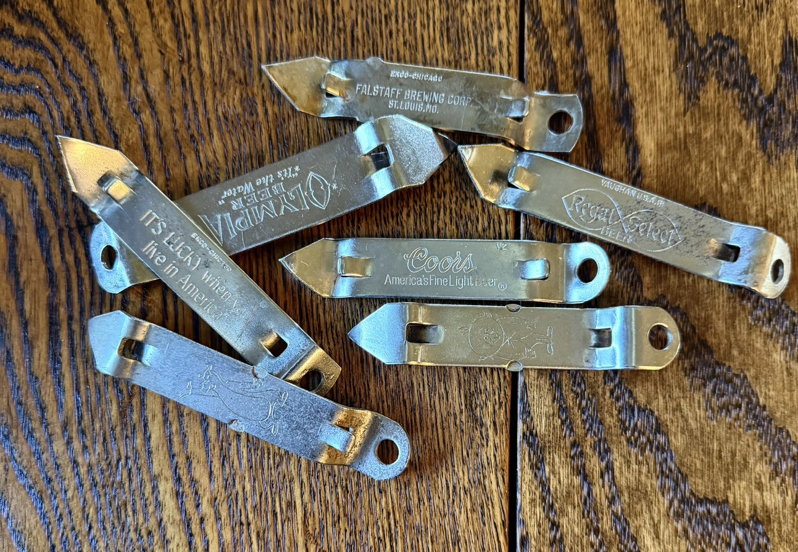 Lot of 7 VTG BOTTLE OPNRS-Olympia Hamms Burgie Lucky Regal Select Falstaff Coors