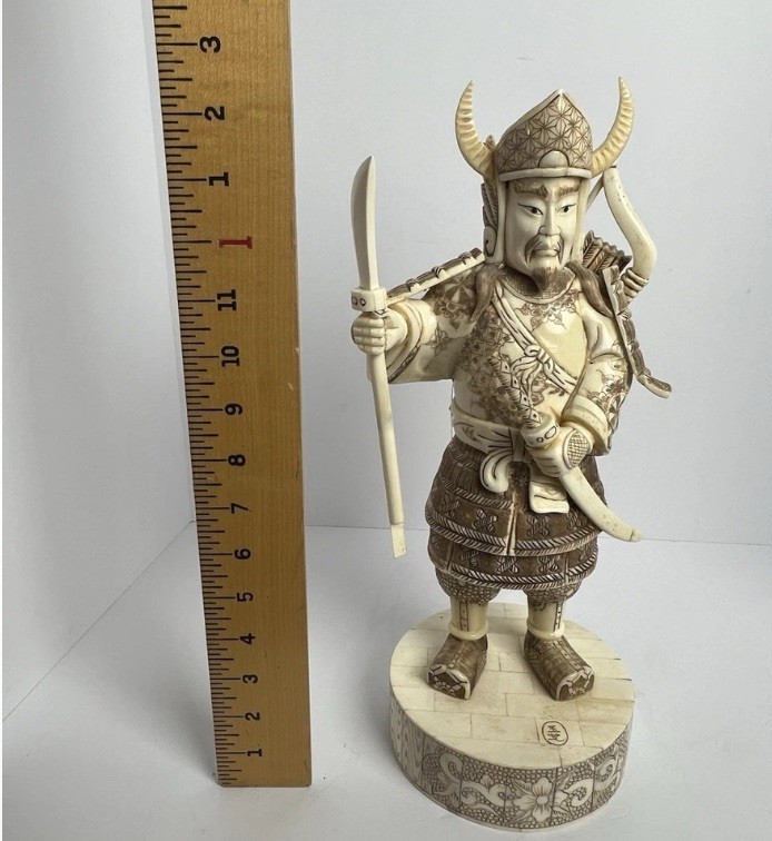 Japanese carved figure is a warrior.