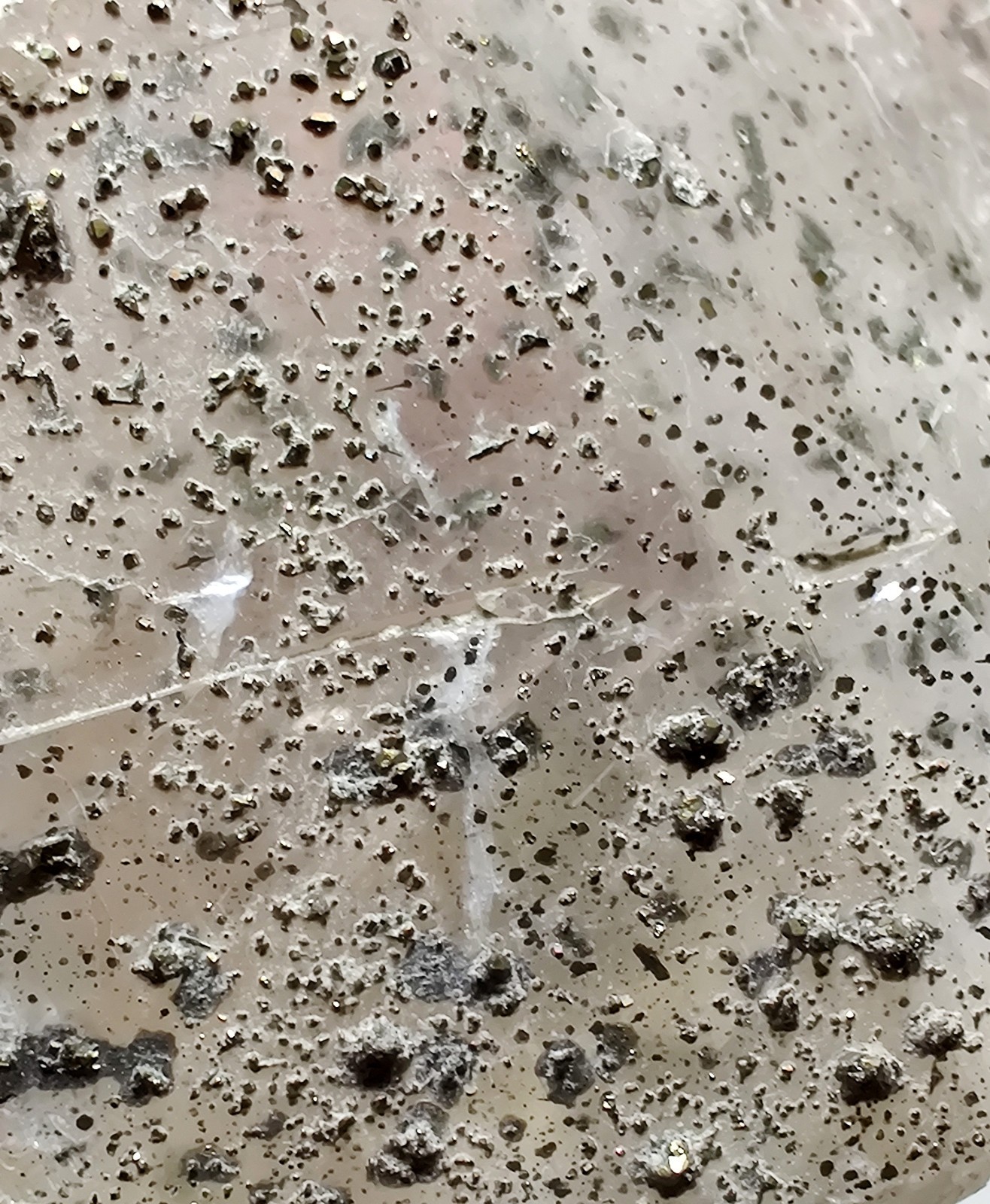 Calcite crystal with Pyrite crystals, fluorescent. Klein Quarry, Iowa. 45 grams.