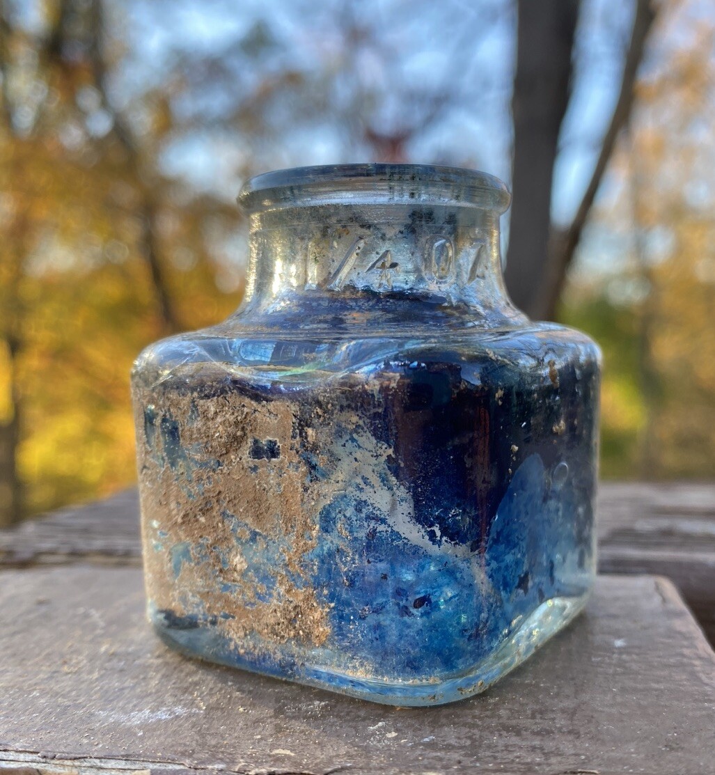 Clear Inkwell With Blue Ink And Partial Label