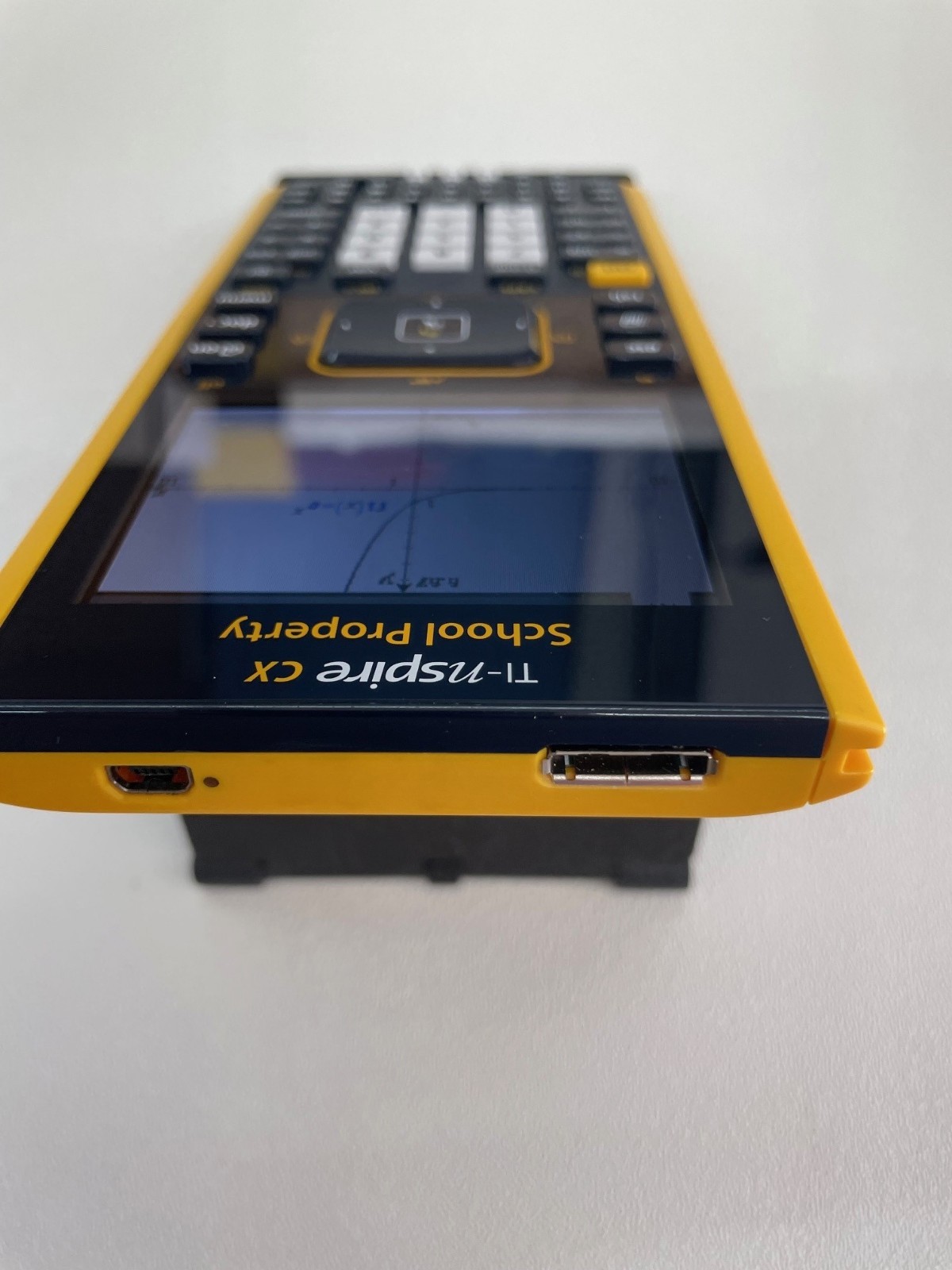 TI Nspire CX Color-Display Graphing Calculator with School Property Markings.