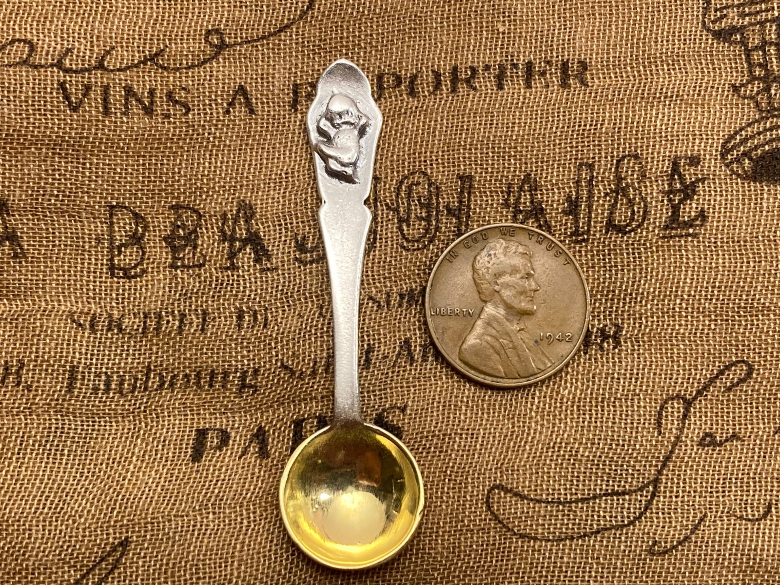 Unique Happy Kewpie Patterned Gilt Sterling silver open salt spoon