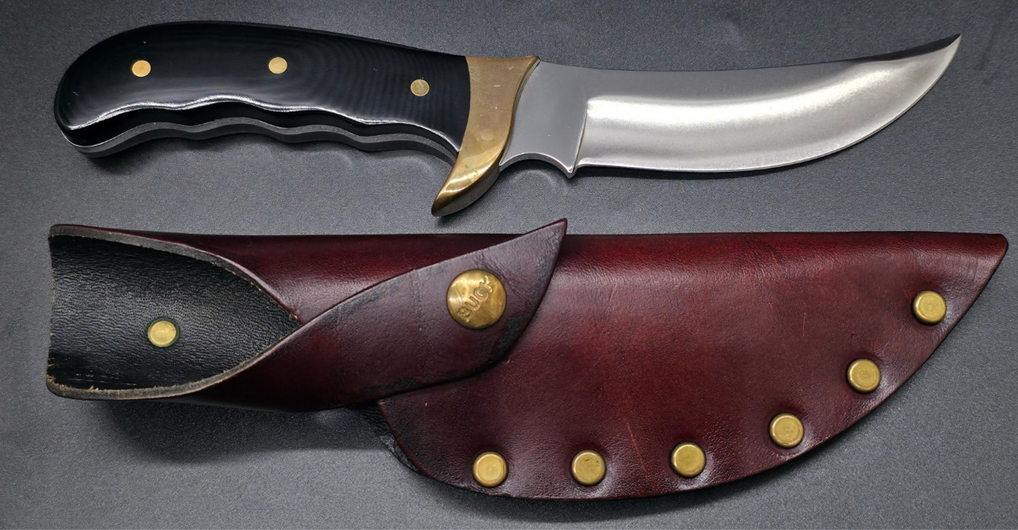 Buck Kalinga knife with black handle and brown leather sheath
