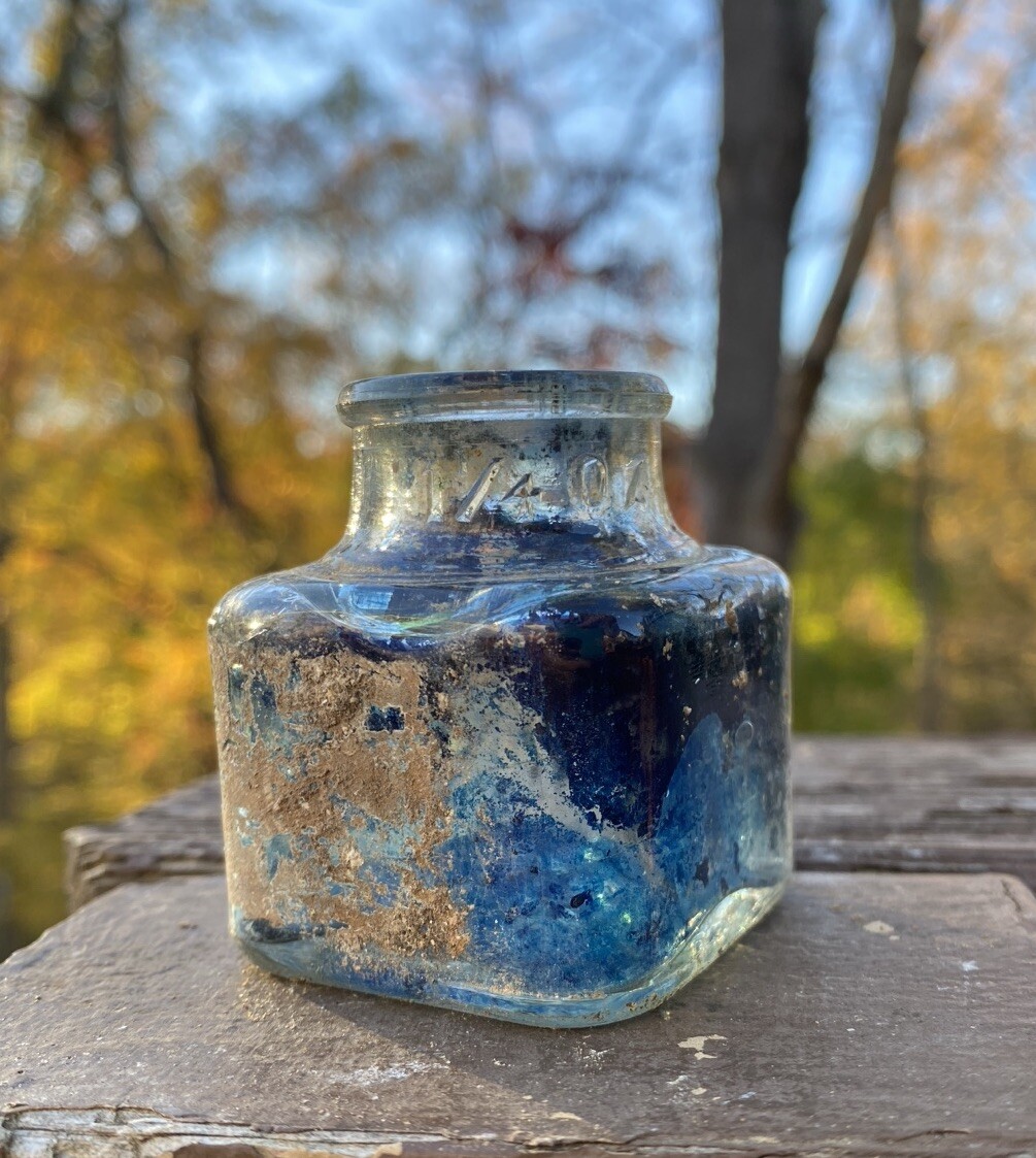 Clear Inkwell With Blue Ink And Partial Label