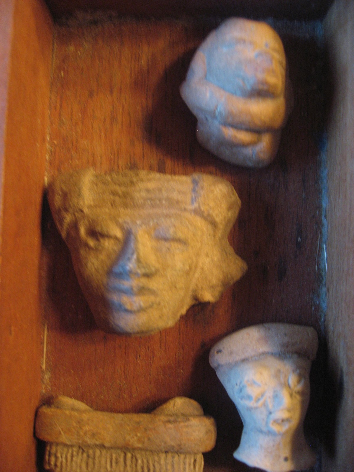 Antique Pre-Columbian Artifacts Box of 12 Hand Carved Stone Face Heads on Wood