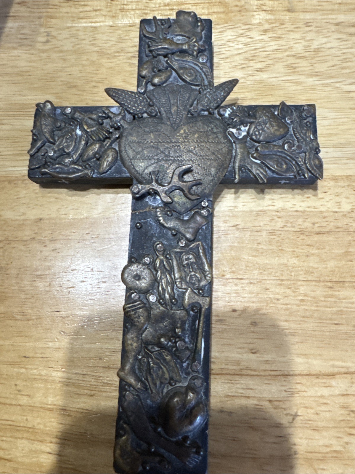 Vintage handmade folk art cross with 35+ brass milagros signed Gonzalez 1993