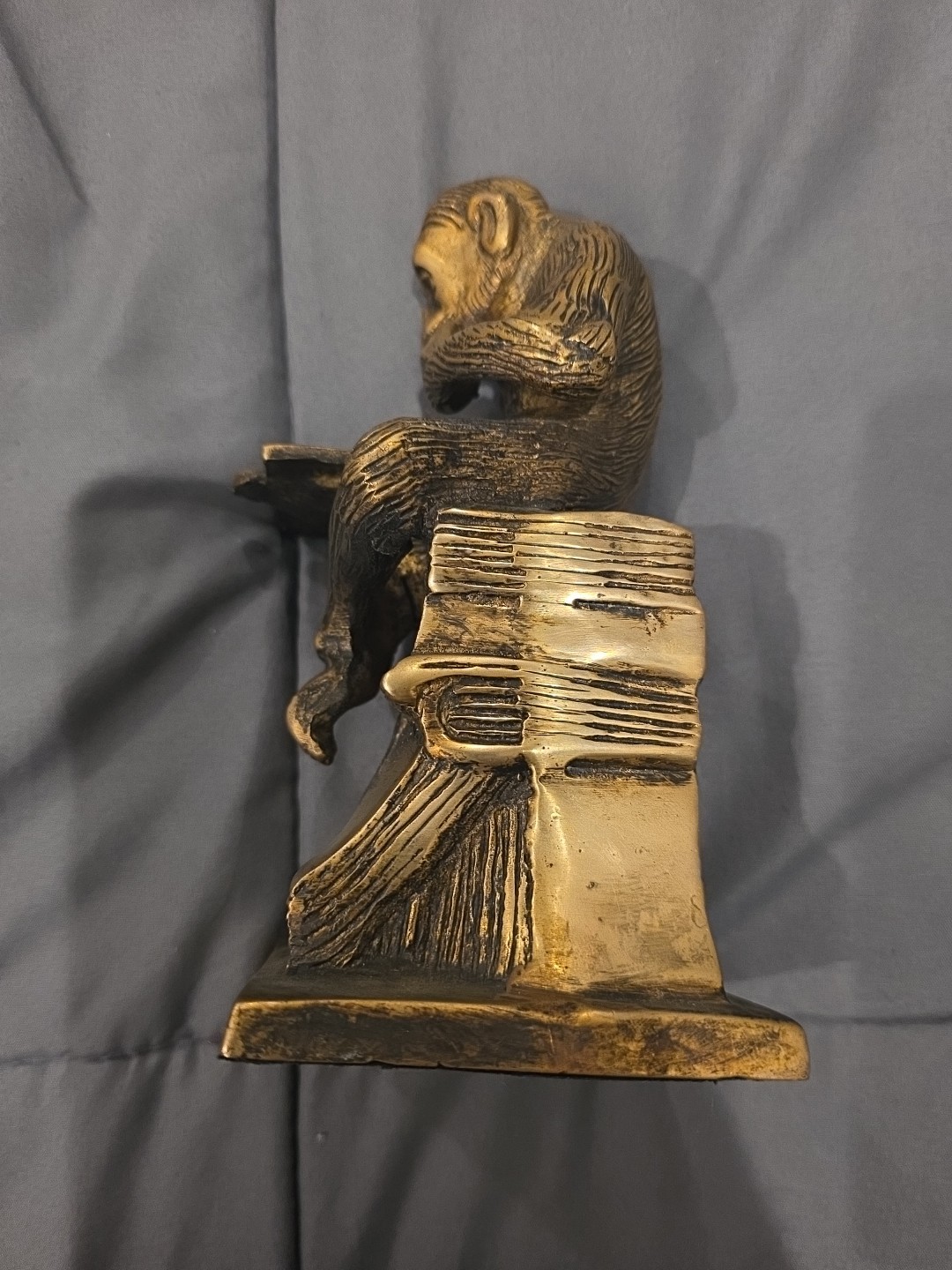 Bronze sculpture. Monkey with a book.