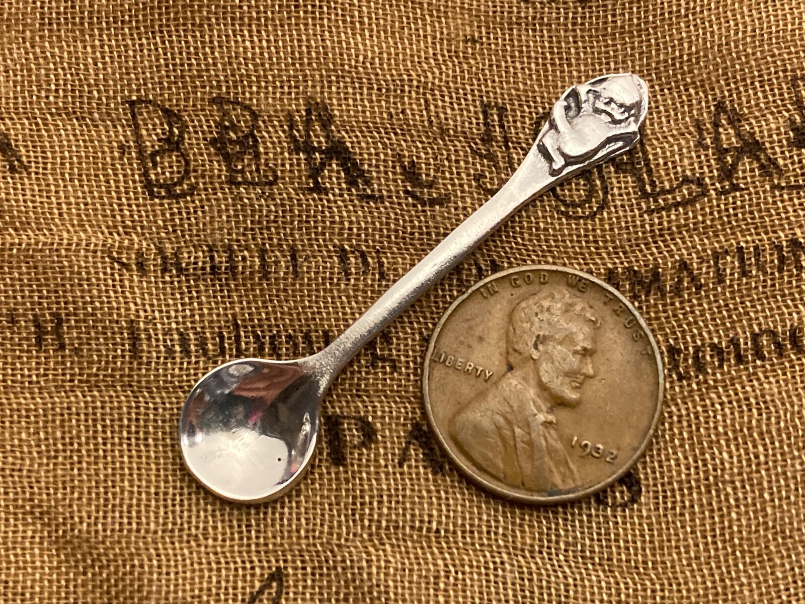 Unique Happy Kewpie Patterned Sterling silver open salt spoon