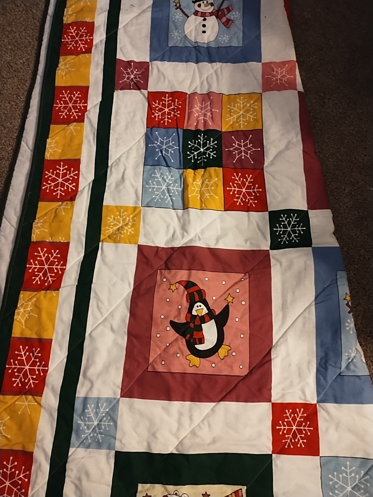 quilt featuring a winter scene with a snowman, reindeer, and penguin Q/F
