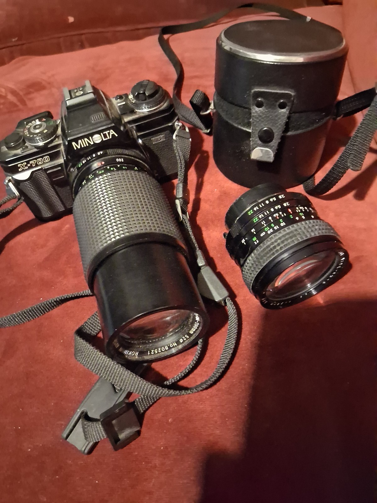 Minolta X-700 35mm film camera with two lenses and a camera case.