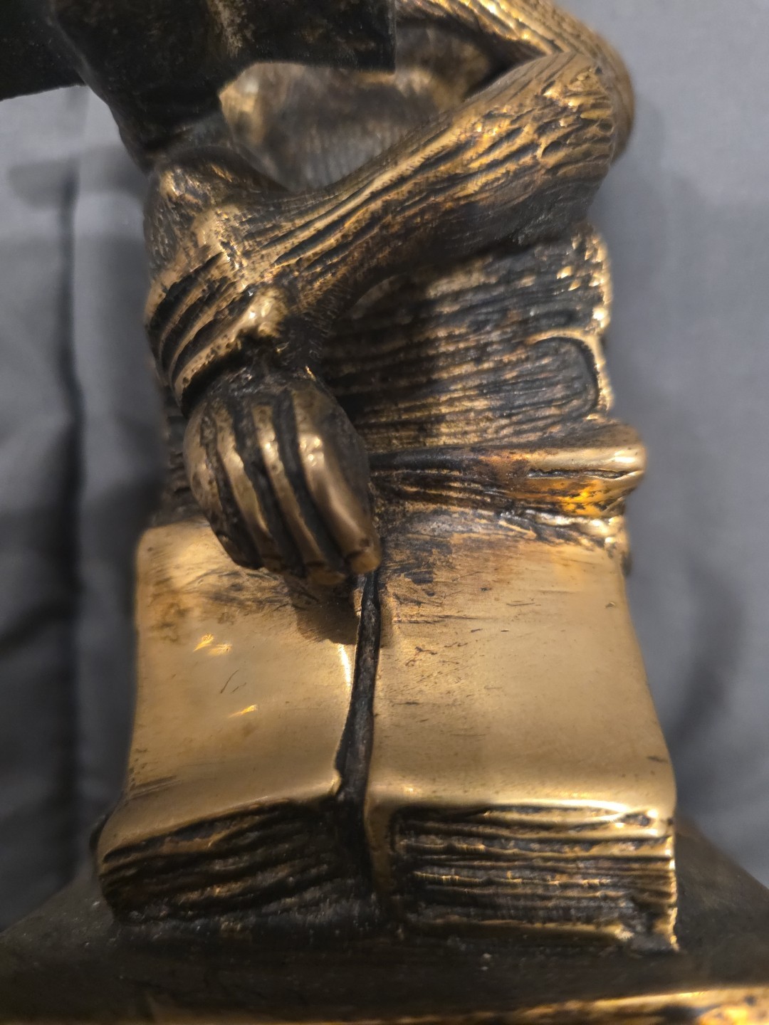 Bronze sculpture. Monkey with a book.