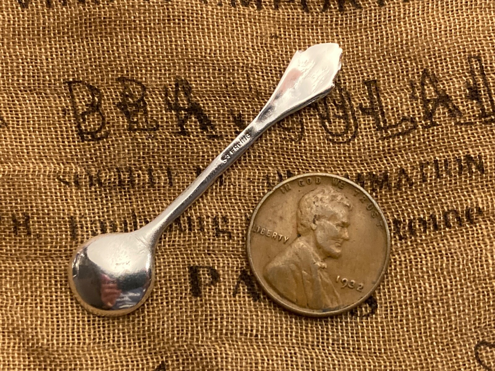 Unique Happy Kewpie Patterned Sterling silver open salt spoon